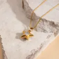 Detailed shot of gold stainless steel star pendant necklace with sparkling stone, dainty collar chain. - White