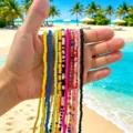 Close-up of colorful bohemian beaded waist chains held against a sunny tropical beach - 10 Strands Pack / Mixed Colors