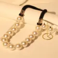 Detail of luxury big pearl necklace with black rope and matching earrings on gold stand - Necklace And Earrings Set (X-783) / Milky White