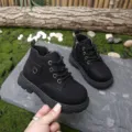 Close-up of black leather children's Martin boots showing texture and thick non-slip sole - Size 21 (14cm) / Black