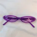 Modische schmale ovale Sonnenbrille in Lila mit transparentem Kunststoffrahmen für Damen. - Flache Form Lila