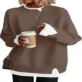 Detailed view of the brown layered sweater showing the contrast white collar and ribbed cuffs. - S / Brown