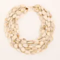 Macro detail view of a multi-layer marbled cream acrylic beaded necklace with gold hardware. - Cream White (X-1146)