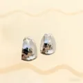 Primo piano di orecchini a cerchio argentati martellati, gioielli moderni ed eleganti. - Argento Martellato