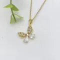 Primo piano di una collana con ciondolo a farfalla dorata con zirconi cubici brillanti. - Farfalla Svuotata Zirconia Bianca (XL2118-5)