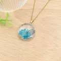 Dettaglio della collana in acciaio inossidabile con pendente in resina blu e fiori. - Stile Tondo Floreale Farfalla Blu (XL2171-09)