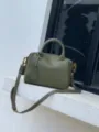Détail de sac Boston en cuir vert olive, sac à main poignée supérieure avec bandoulière. - Vert olive