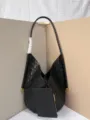 Black woven leather shoulder bag detail showing premium intrecciato texture and design. - Black
