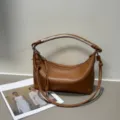 Brown leather shoulder bag with hand-woven handle and stylish dumpling shape for women daily use. - Blank / Brown