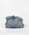 Woven cloud clutch bag with stylish knotted handle and premium braided texture design. - Denim Blue