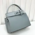 Light blue leather top handle bag featuring a studded strap, classic luxury retro style. - Grail Blue