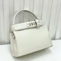 Premium white leather top handle handbag with chic pyramid stud strap design elegant retro style. - Milk White