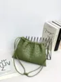 Detailed view of green woven leather shoulder bag with drawstring closure and fine straps. - 32*21*1cm / Travertine Green