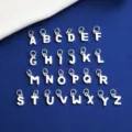 Detailed view of 26 polished 925 sterling silver alphabet letter charms for DIY jewelry - Letter A / Silver