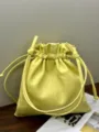 Close-up detail of yellow soft leather pouch bag, luxury drawstring bucket handbag texture view. - 28*28*2cm / Light Yellow