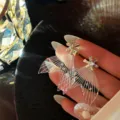 Exquisite fairy wing earrings featuring sparkling crystal flower studs, elegant detail shot. - Fish Tail Flower