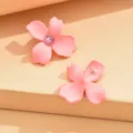 Pink flower stud earrings with sparkling center crystal, cute minimalist jewelry detail shot. - Pink