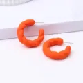 Orange twisted C-shaped hoop earrings for women, simple and stylish everyday jewelry. - Orange