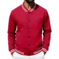Close-up detail view of the red varsity baseball jacket featuring black snap buttons and white stripes. - S / Tops / Red