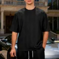Black textured knit short sleeve t-shirt detail showing premium fabric and relaxed fit. - S / Tops / Black