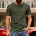 Detail view of men's short sleeve olive green Henley shirt with button placket in casual setting. - S / Army Green