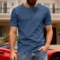 Close-up view of a men casual blue short sleeve Henley shirt with button placket detail. - Denim Blue
