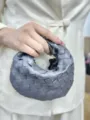 Detailed view of the woven leather handbag, showcasing exquisite intrecciato craftsmanship. - Gray