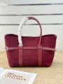 Detail shot of burgundy suede tote bag with protective handle wrap and stylish horizontal belt. - Blank / Burgundy