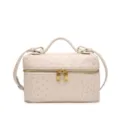 Detailed view of the beige ostrich textured vanity bag with woven sides and gold zippers. - Off White