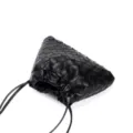 Close-up detail of the black woven leather pouch bag, highlighting intricate intrecciato texture. - Black