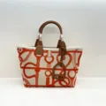 Canvas leather tote bag with equestrian print and stirrup charm for daily fashion use. - Orange and Brown