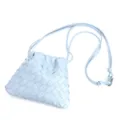 Close-up detail of light blue woven leather crossbody bag with drawstring and thin strap. - Glacier Blue