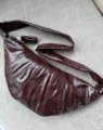 Dark red crinkled patent leather croissant shoulder bag with knotted strap and stylish design. - Small 35*16cm / Lava Chocolate