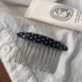 Detail shot of black acetate polka dot insert comb with wire teeth for styling bangs and hair. - Black With White Polka Dots