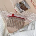 Close-up detail of a sweet red and white acetate bow hair side comb on lace and book prop. - Long Bowknot Insert Comb / White Red Double Layer