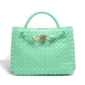 Mint green woven leather handbag detail showing delicate artisanal craftsmanship and metal knot. - Siren Blue