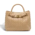 Detailed view of women's woven leather handbag with elegant knot metal hardware. - Taupe