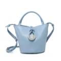 Light blue bucket bag detail showing the braided knot and metallic ring design element. - Blue