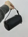 Black leather 90s cylinder shoulder bag, minimalist chic barrel handbag variant for women. - Black