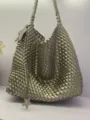 Detailed view of the metallic silver woven bucket shoulder bag featuring a stylish star charm. - Small: 21*12*22cm / Gunmetal
