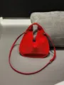 Red suede triangular handbag detail showing the soft leather texture and cutout handle design. - 27*2*30cm / Red