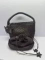 Brown woven bucket bag with matching drawstring pouch and star charms for casual use. - Coffee