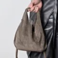 Suede triangle dumpling handbag detail shot, showing the texture and handle design. - 27*2*30cm / Gray