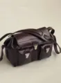 Detailed view of the dark brown leather motorcycle messenger bag with dual front pockets and metal locks. - Blank / Medium Eggplant Purple 30cm
