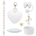 White Stanley cup accessories set including bow straw cover, plush heart and braided strap. - White