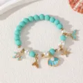 Ozean Stil Perlenarmband mit Seestern Muschel Anhängern, ideal für Sommer Strand und Alltag. - Armband / Cyanfarbenes Armband