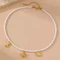 Detailansicht der goldenen Perlenkette mit Ozean Seestern und Fisch Anhängern Strandstil. - Kleiner Fisch Stil (NS0037yu)