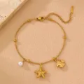 Close-up detail of the gold-tone stainless steel beach anklet featuring charming star and fish pendants. - Starfish Style (FS007haixing)