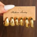 Modisches Set aus goldenen Metall-Creolen und Tropfenohrringen im Vintage-Minimalismus-Stil. - Gold Träne Reifen Set A