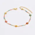 Charming gold-tone metal anklet featuring colorful enamel daisy charms and delicate seed beads. - Multicolor Beaded Style / Multicolor-Colored Daisy